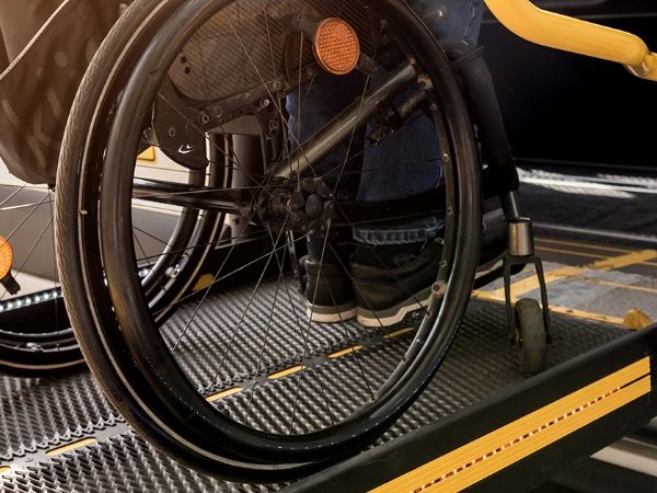 A man in the wheelchair is moving on the expanded metal slope ramps.